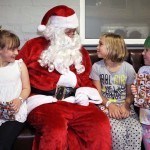 Santa hands out presents at Rof 59 in Newton Aycliffe. Pictured are 7-year-olds Maisie(left), Summer(right) and 8-year-old Katie. Picture by Stuart Boulton.