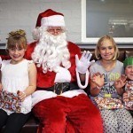 Santa hands out presents at Rof 59 in Newton Aycliffe. Pictured are 7-year-olds Maisie(left), Summer(right) and 8-year-old Katie. Picture by Stuart Boulton. Picture by Stuart Boulton.