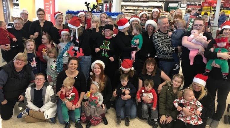 Children’s Down Syndrome project serenades shoppers to say thanks to the local community