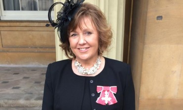 Business leader collects her MBE from the Queen