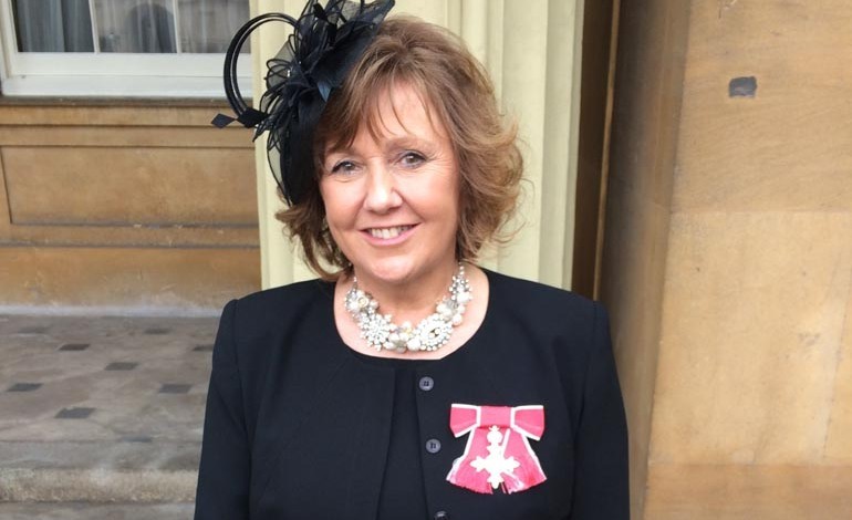 Business leader collects her MBE from the Queen